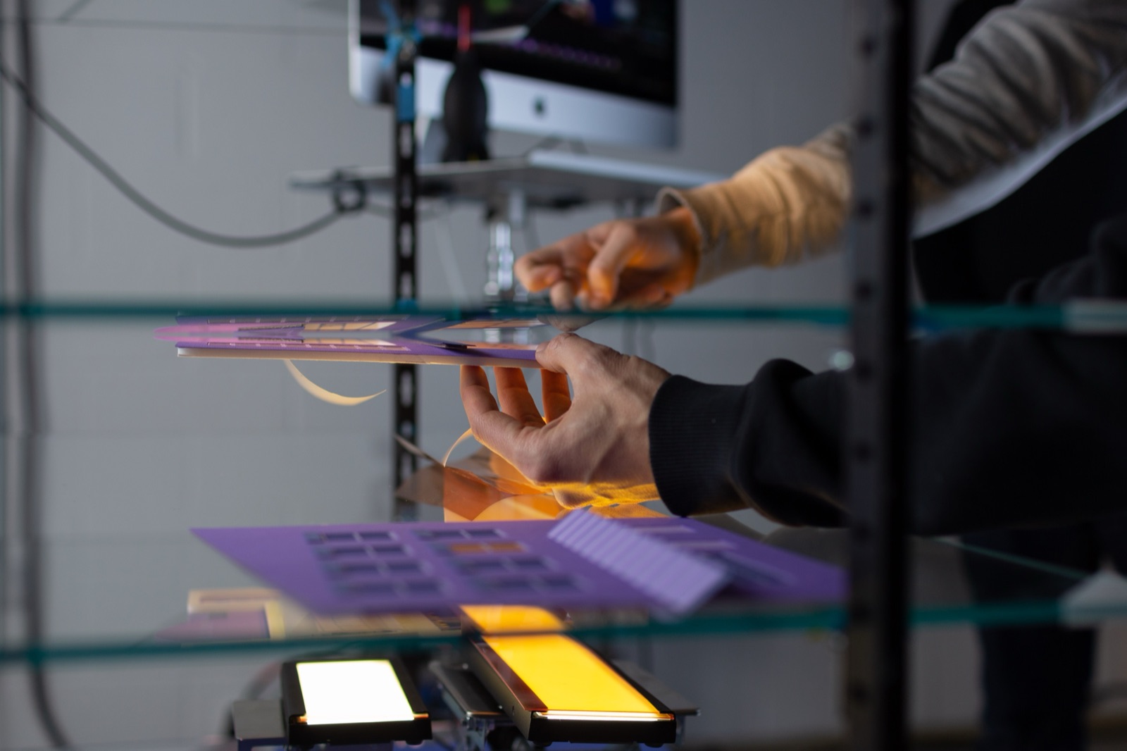 Placing paper elements onto the glass layers of the multi-plane, building up the scene depth